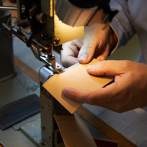 Sewing machine and dbteo logo on leather